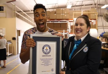 A member of Wrymwood holding up a Guinness World Record certificate