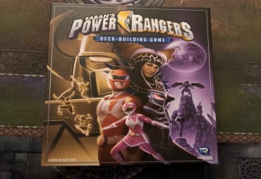 The box for Power Rangers: The Deck-Building Game set on a play mat