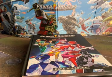 The core rulebook of Power Rangers: The Roleplaying Game, laid out in front of a GM Screen