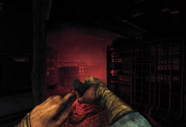 Amnesia The Bunker header of the player pulling the pin on a grenade in a red lit room with a metal cage