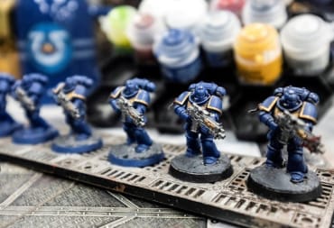 A layout of Space Marine models and paint pots for Warhammer 40k