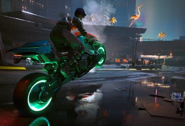 The player riding a bike through Night City in Cyberpunk 2077