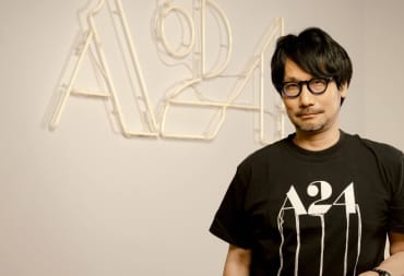 Hideo Kojima standing in front of an A24 logo and wearing an A24 shirt for the Death Stranding movie