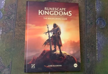 A screenshot of the Runescape Kingdoms The Roleplaying Game core rulebook on a gaming mat.
